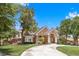 Stunning two-story home features a circular driveway, beautiful brick accents, and mature trees at 3102 La Mirada Ave, Las Vegas, NV 89120