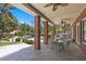 Outdoor patio with brick columns features a ceiling fan, dining set, and barbecue, perfect for entertaining at 3102 La Mirada Ave, Las Vegas, NV 89120