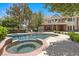 A backyard boasts a luxurious pool and spa, perfect for relaxation and entertaining at 3102 La Mirada Ave, Las Vegas, NV 89120