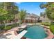 Backyard pool with diving board, surrounded by a brick border and lush landscaping at 3102 La Mirada Ave, Las Vegas, NV 89120