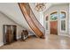 Elegant curved staircase featuring iron railings and a tiled foyer at 3102 La Mirada Ave, Las Vegas, NV 89120