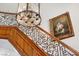 Detailed view of the elegant staircase with wrought iron railings and a floral painting at 3102 La Mirada Ave, Las Vegas, NV 89120