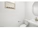 Half bath with modern sink, toilet, mirror and window at 340 Taylor St, Henderson, NV 89015