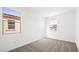 This carpeted bedroom boasts windows providing views of neighboring homes and the surrounding landscape at 340 Taylor St, Henderson, NV 89015