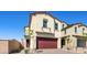 A two-story home features a red two-car garage door and a paver driveway at 340 Taylor St, Henderson, NV 89015