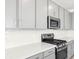 Modern kitchen detail with stainless appliances, gas range and white countertops at 340 Taylor St, Henderson, NV 89015