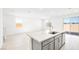 Bright kitchen island and living room, with tile floors and stainless faucet at 340 Taylor St, Henderson, NV 89015