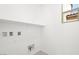 This laundry room features a shelf, window, and hookups for a washer and dryer at 340 Taylor St, Henderson, NV 89015
