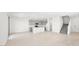 Bright open concept living space with white wood floors adjacent to modern kitchen with island at 340 Taylor St, Henderson, NV 89015