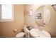 Cozy bathroom featuring a decorative round mirror, and warm neutral paint at 3468 Isle Dr, Las Vegas, NV 89141