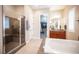 Bathroom featuring a glass shower and separate soaking tub at 3468 Isle Dr, Las Vegas, NV 89141