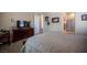 Comfortable bedroom featuring carpet, en suite bathroom, and television at 3468 Isle Dr, Las Vegas, NV 89141