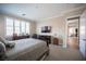 Bedroom with natural light, large window, cozy bed, and a TV at 3468 Isle Dr, Las Vegas, NV 89141