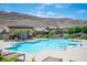 Inviting community pool area with ample seating and a mountain view, perfect for residents to unwind at 3468 Isle Dr, Las Vegas, NV 89141