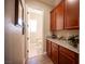 Hallway leading to bathroom, granite countertops and wood cabinets at 3468 Isle Dr, Las Vegas, NV 89141