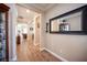 Bright hallway with wood floors, neutral walls, and decorative accents creating a warm and inviting atmosphere at 3468 Isle Dr, Las Vegas, NV 89141