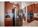 Modern kitchen featuring stainless steel appliances, granite countertops, and custom cabinetry at 3468 Isle Dr, Las Vegas, NV 89141