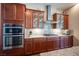 Stylish kitchen showcasing stainless steel appliances, granite countertops, and decorative glass cabinets at 3468 Isle Dr, Las Vegas, NV 89141