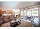 Comfortable living room with plush seating, a large sliding glass door, and an open layout to the kitchen at 3468 Isle Dr, Las Vegas, NV 89141
