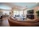 Spacious living room featuring stylish furniture, a fireplace, and sliding glass doors leading to an outdoor patio at 3468 Isle Dr, Las Vegas, NV 89141