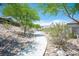 Charming pathway winding through a community with mature trees and well-maintained landscaping at 3468 Isle Dr, Las Vegas, NV 89141