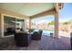 Covered outdoor patio with comfortable seating, overlooking the pool area for relaxed outdoor enjoyment at 3468 Isle Dr, Las Vegas, NV 89141