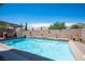 Beautiful pool with waterfalls, covered patio, and lounge chairs, perfect for outdoor relaxation at 3468 Isle Dr, Las Vegas, NV 89141