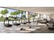 Bright gym with cardio machines and floor-to-ceiling windows overlooking tropical landscaping at 410 Rock Peak Dr # 1704, Henderson, NV 89012
