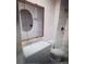 Updated bathroom with a granite-topped vanity, framed mirror, and tiled shower at 4184 Lady Lucille Ct, Las Vegas, NV 89115