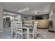 Open-concept dining area with modern light fixture and easy access to the kitchen and living room at 4204 Sprints Race Ave, North Las Vegas, NV 89084