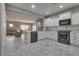Open kitchen with stainless steel appliances and seamless flow into living and dining areas at 4204 Sprints Race Ave, North Las Vegas, NV 89084