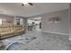 Open concept living room showcasing a sofa, bar seating, and a view into the modern kitchen at 4204 Sprints Race Ave, North Las Vegas, NV 89084