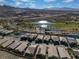 Picturesque aerial community view of houses adjacent to golf course, pond, and desert landscaping at 44 Alta Cascata Pl, Henderson, NV 89011