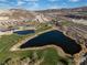 Wide aerial view of a golf course community featuring multiple ponds and lush green landscapes at 44 Alta Cascata Pl, Henderson, NV 89011