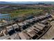 Community aerial view of houses next to golf course and pond at 44 Alta Cascata Pl, Henderson, NV 89011