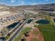 Aerial view of a community featuring desert landscaping, a road, lakes and a golf course at 44 Alta Cascata Pl, Henderson, NV 89011