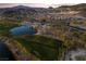 Scenic aerial view of a lush golf course community with stunning mountain views at sunset at 44 Alta Cascata Pl, Henderson, NV 89011