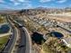 Panoramic aerial view of a desert community featuring multiple ponds and mature palm trees at 44 Alta Cascata Pl, Henderson, NV 89011
