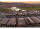 Picturesque aerial shot of homes with tile roofs, solar panels, and access to a nearby golf course and scenic ponds at 44 Alta Cascata Pl, Henderson, NV 89011
