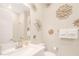 Bright half bath featuring white cabinets, designer artwork, and a sink at 44 Alta Cascata Pl, Henderson, NV 89011