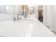 Bathroom with double sinks and a sleek white countertop, next to an open closet at 44 Alta Cascata Pl, Henderson, NV 89011