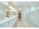 Modern bathroom showcasing double sinks, white cabinets, tile flooring, and glass enclosed shower at 44 Alta Cascata Pl, Henderson, NV 89011