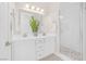 Bright and airy bathroom with double sinks, a large mirror, and a glass-enclosed shower at 44 Alta Cascata Pl, Henderson, NV 89011