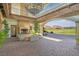 Outdoor living space with fireplace, exposed beams, and scenic golf course views at 44 Alta Cascata Pl, Henderson, NV 89011