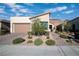 Charming single-story home with a well-manicured lawn, desert landscaping, and a brick driveway at 44 Alta Cascata Pl, Henderson, NV 89011