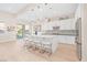 A bright, spacious kitchen with a large island, stainless steel appliances, and modern pendant lighting at 44 Alta Cascata Pl, Henderson, NV 89011