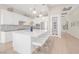 The kitchen has white cabinets, stainless appliances, a large island, and a peek into another room at 44 Alta Cascata Pl, Henderson, NV 89011