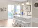 A view of the kitchen island with white countertops, stylish stools, and a view to the backyard at 44 Alta Cascata Pl, Henderson, NV 89011