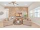 Spacious living room offers herringbone accent wall, modern ceiling fan, and lots of natural light at 44 Alta Cascata Pl, Henderson, NV 89011