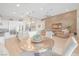 An open living space featuring a gourmet kitchen, a wood accent wall, and modern furniture at 44 Alta Cascata Pl, Henderson, NV 89011
